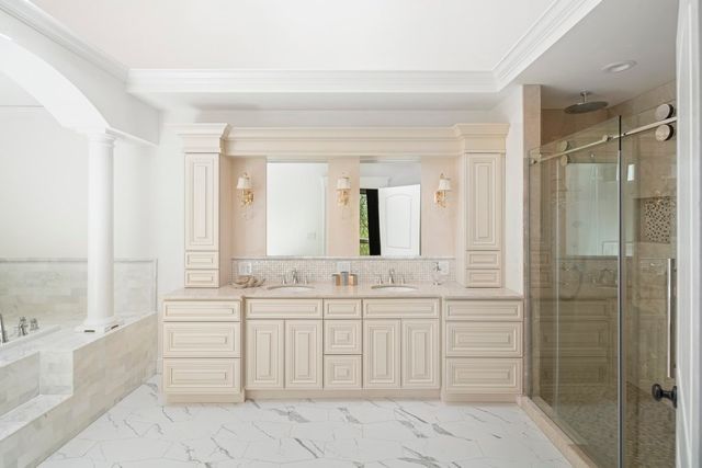 a spacious bathroom with a shower sink and mirror