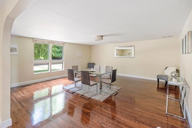 a dining room with furniture a rug and wooden floor