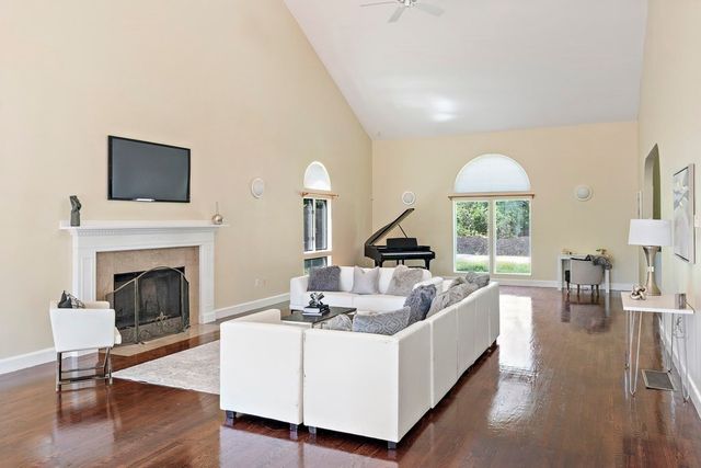 a living room with furniture fireplace and a large window