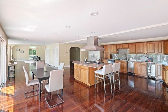 a dining room with furniture and wooden floor
