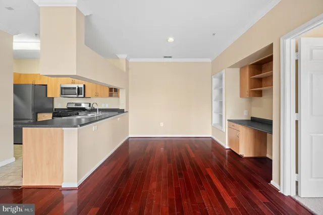 a kitchen with wooden floors and wooden cabinets