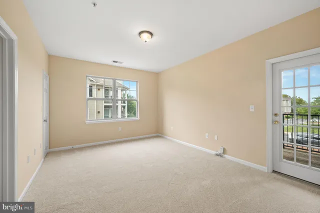 an empty room with windows and entrance