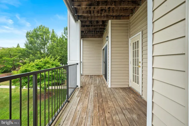 a view of a balcony with wooden floor