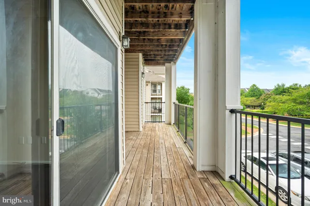 a view of a balcony with wooden floor