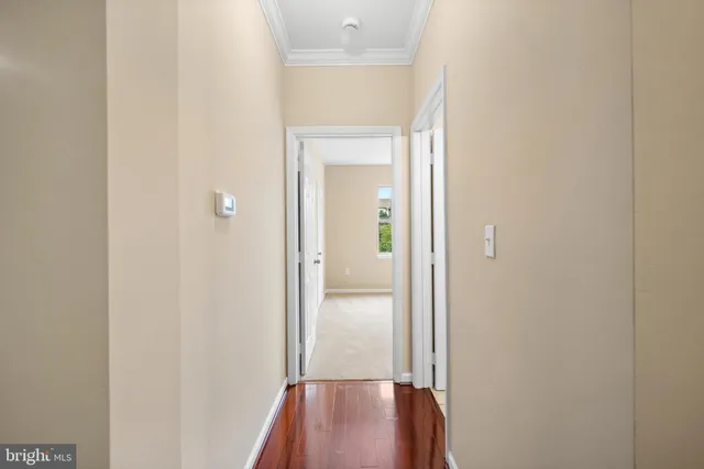 a view of a hallway with wooden floor
