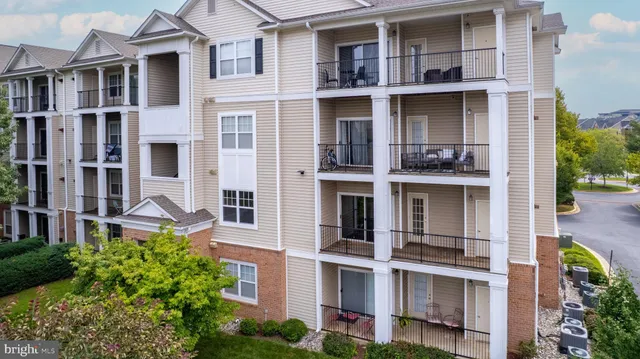 a view of a brick building next to a yard