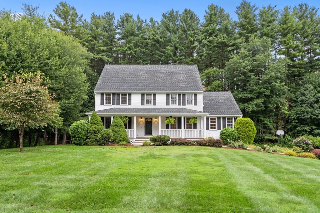 318 Reed Farm Road Boxborough, MA 01719 - Photo 1 of 42 a front view of a house with a yard table and chairs