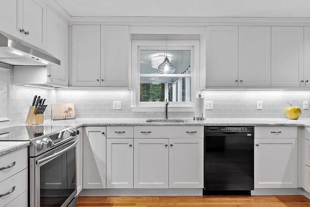 318 Reed Farm Road Boxborough, MA 01719 - Photo 13 of 42 a kitchen with granite countertop a sink cabinets stainless steel appliances and a window