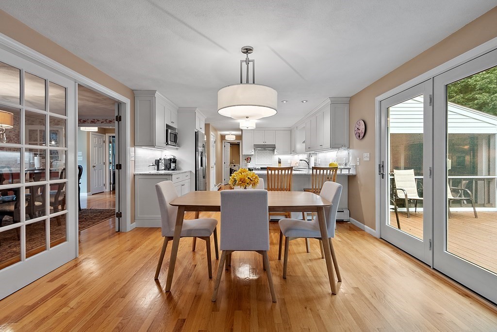 318 Reed Farm Road Boxborough, MA 01719 - Photo 16 of 42 a dining room with furniture a chandelier and wooden floor