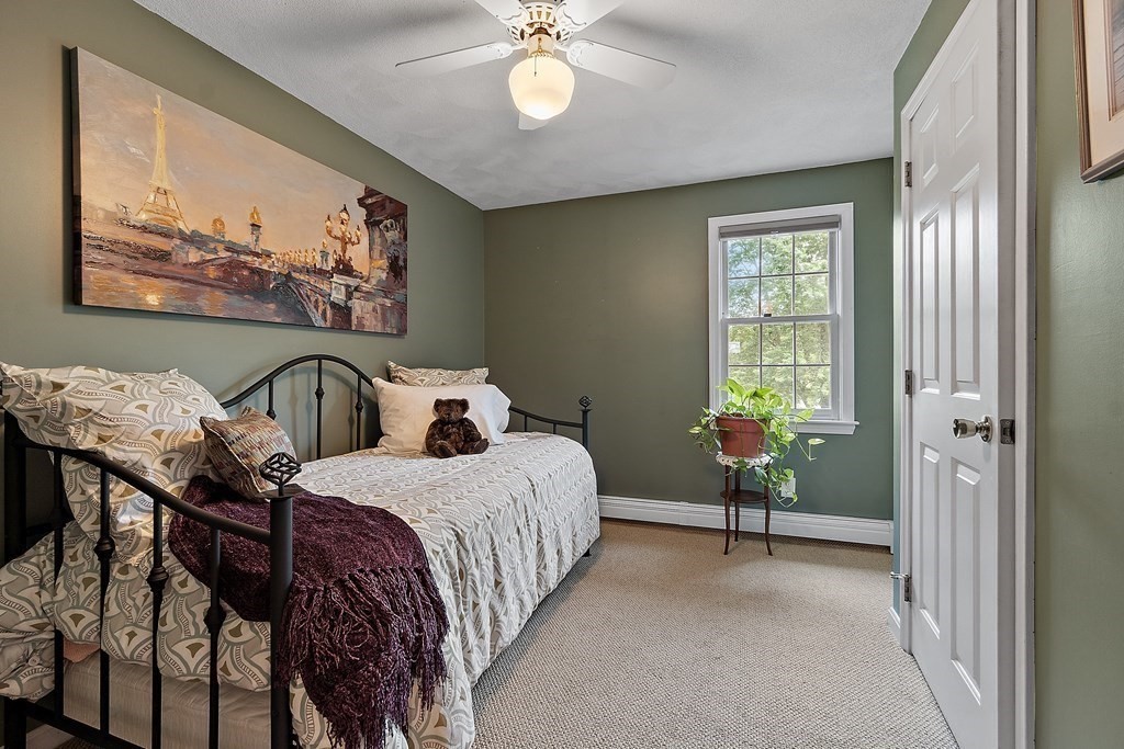 318 Reed Farm Road Boxborough, MA 01719 - Photo 32 of 42 a bedroom with a bed and a chandelier