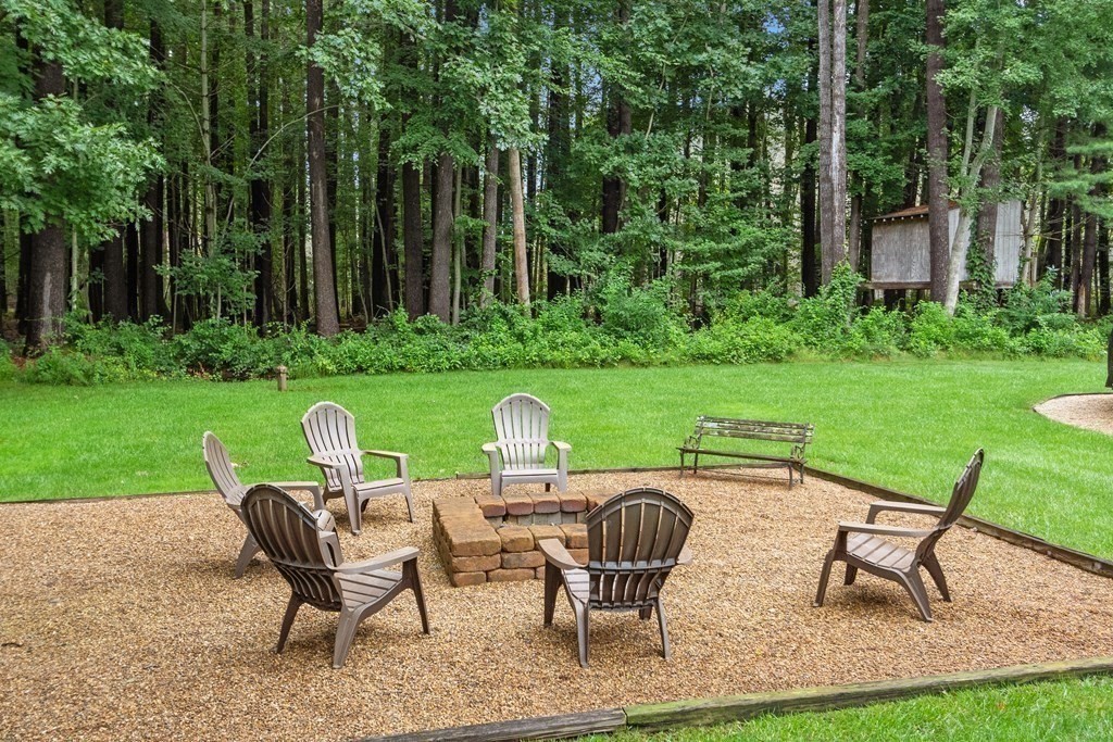 318 Reed Farm Road Boxborough, MA 01719 - Photo 37 of 42 a view of a chairs and table in patio next to a yard