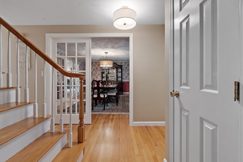 318 Reed Farm Road Boxborough, MA 01719 - Photo 7 of 42 a view of a hallway with wooden floor and staircase