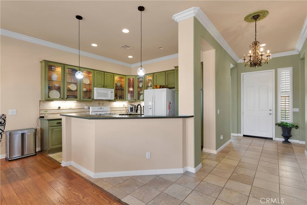 10686 Archerwill Road Apple Valley, CA 92308 - Photo 15 of 55 a kitchen with kitchen island granite countertop a refrigerator a oven a island and a sink