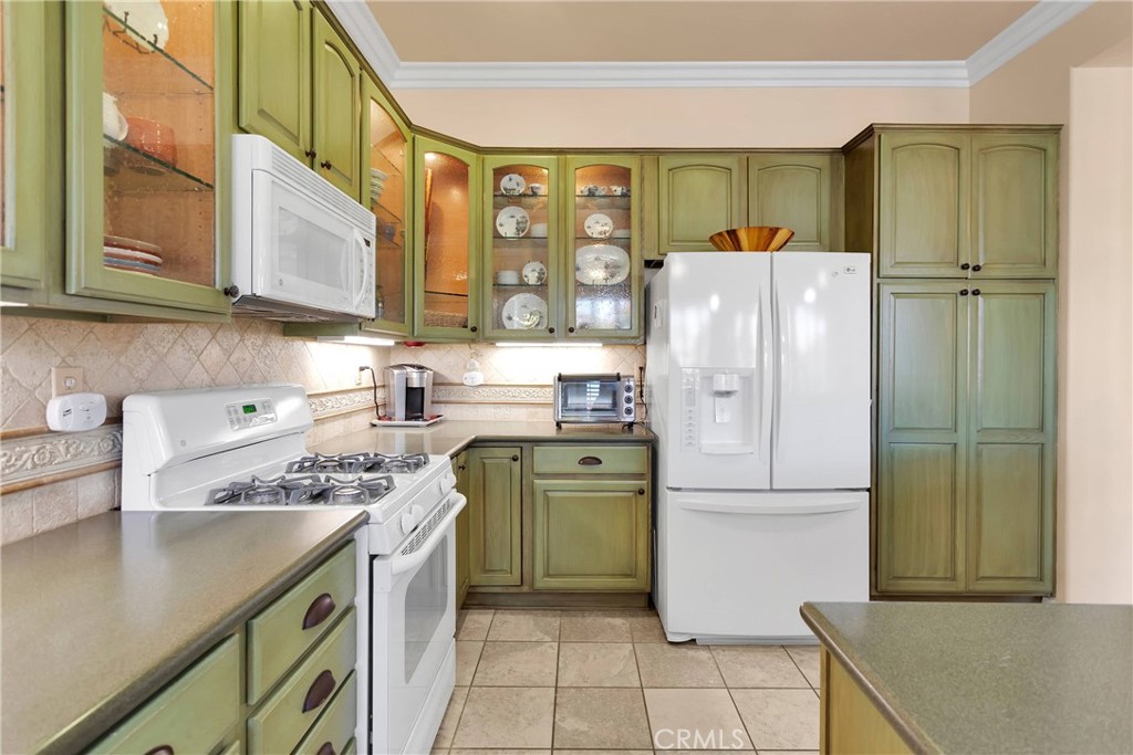 10686 Archerwill Road Apple Valley, CA 92308 - Photo 16 of 55 a kitchen with a sink a refrigerator and cabinets