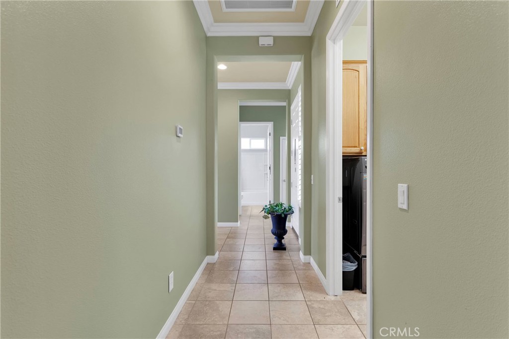 10686 Archerwill Road Apple Valley, CA 92308 - Photo 21 of 55 a view of a hallway with a potted plant in front of a door