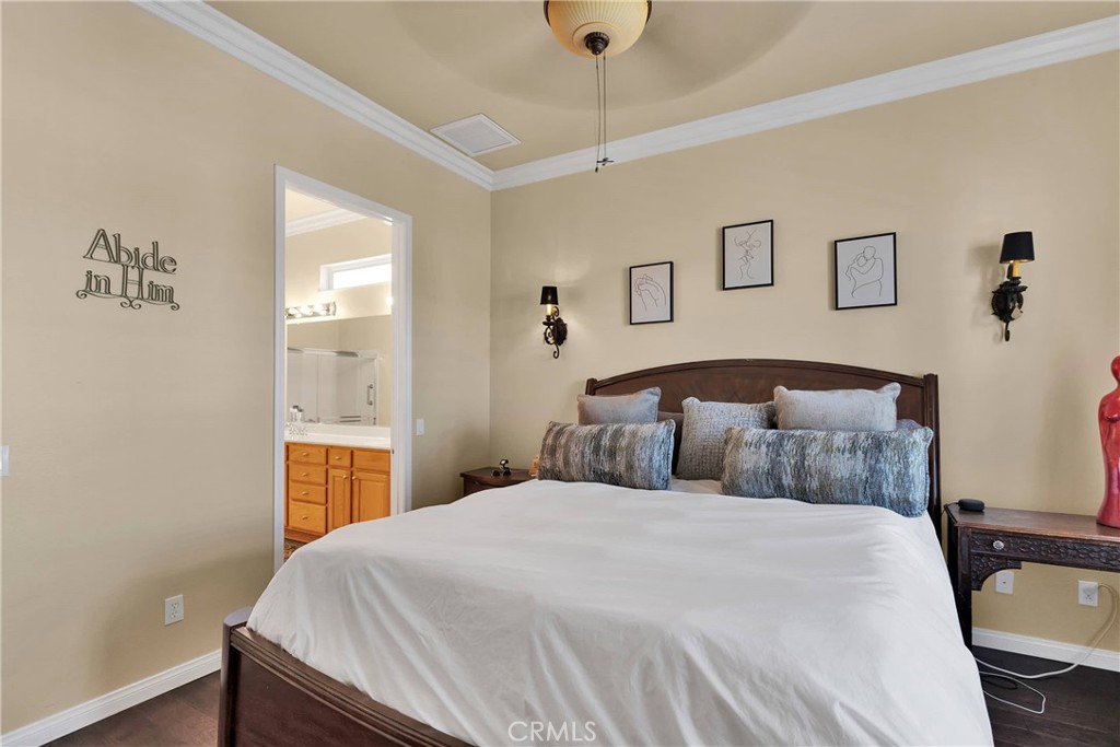 10686 Archerwill Road Apple Valley, CA 92308 - Photo 28 of 55 a bedroom with a bed and a chandelier