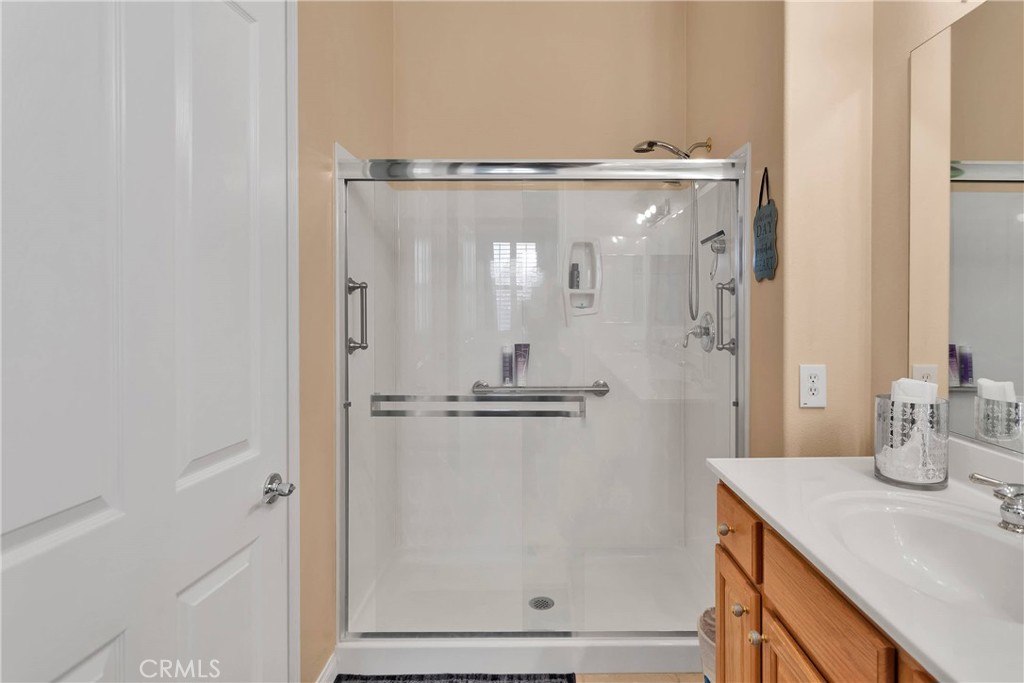10686 Archerwill Road Apple Valley, CA 92308 - Photo 31 of 55 a bathroom with a granite countertop shower sink and mirror