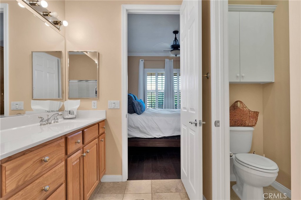 10686 Archerwill Road Apple Valley, CA 92308 - Photo 32 of 55 a en suite bathroom with a granite countertop sink and a mirror