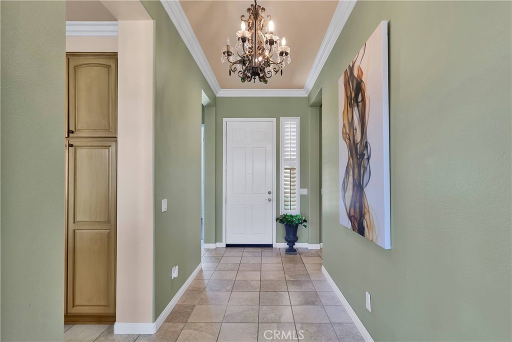 10686 Archerwill Road Apple Valley, CA 92308 - Photo 8 of 55 a view of a hallway with windows and chandelier