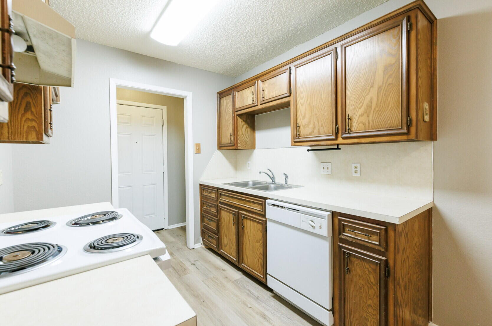 6112 38th Street, Unit A Lubbock, TX 79407 - Photo 8 of 15 a kitchen with stainless steel appliances granite countertop a stove and a refrigerator