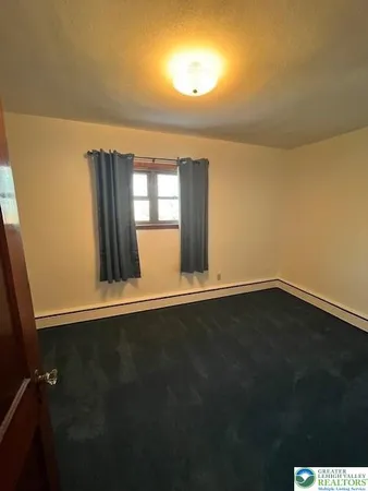 a view of wooden floor and windows in a room