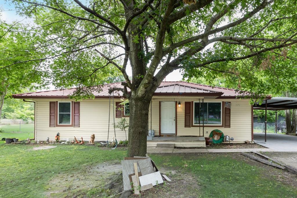 571 South 1st Street Point, TX 75472 - Photo 2 of 27 a front view of a house with a yard and porch