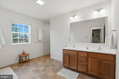a bathroom with a toilet a sink and a mirror