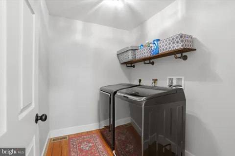 a view of a balcony with chairs and a patio