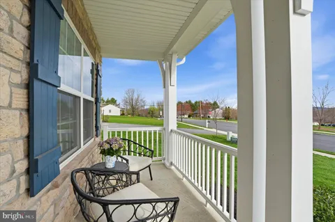 a view of a chair and tables in the balcony