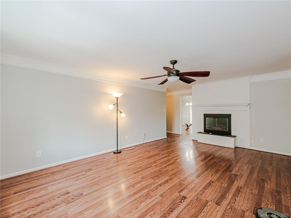1708 Roxborough Road Charlotte, NC 28211 - Photo 8 of 27 a view of empty room with wooden floor and ceiling fan