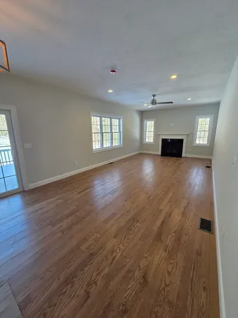 wooden floor in an empty room with a window