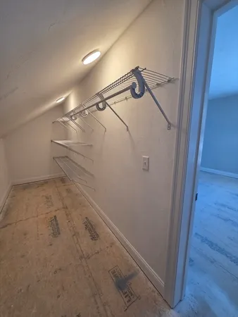 a view of a hallway with a glass door and a window