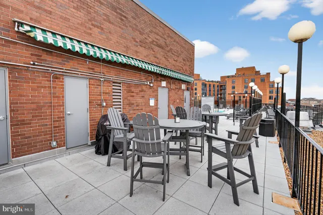 a view of a patio with a table and chairs