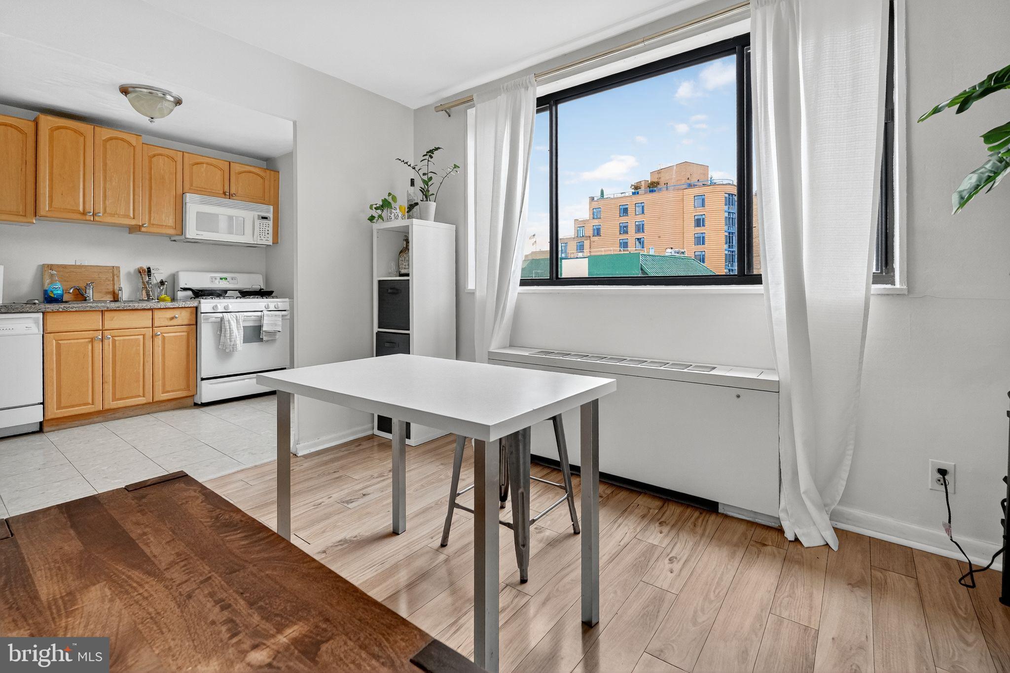 1420 N Street Northwest, Unit 1013 Washington, DC 20005 - Photo 2 of 27 a view of a kitchen with workspace and wooden floor