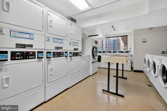 a kitchen with stainless steel appliances a chimney a sink and cabinets