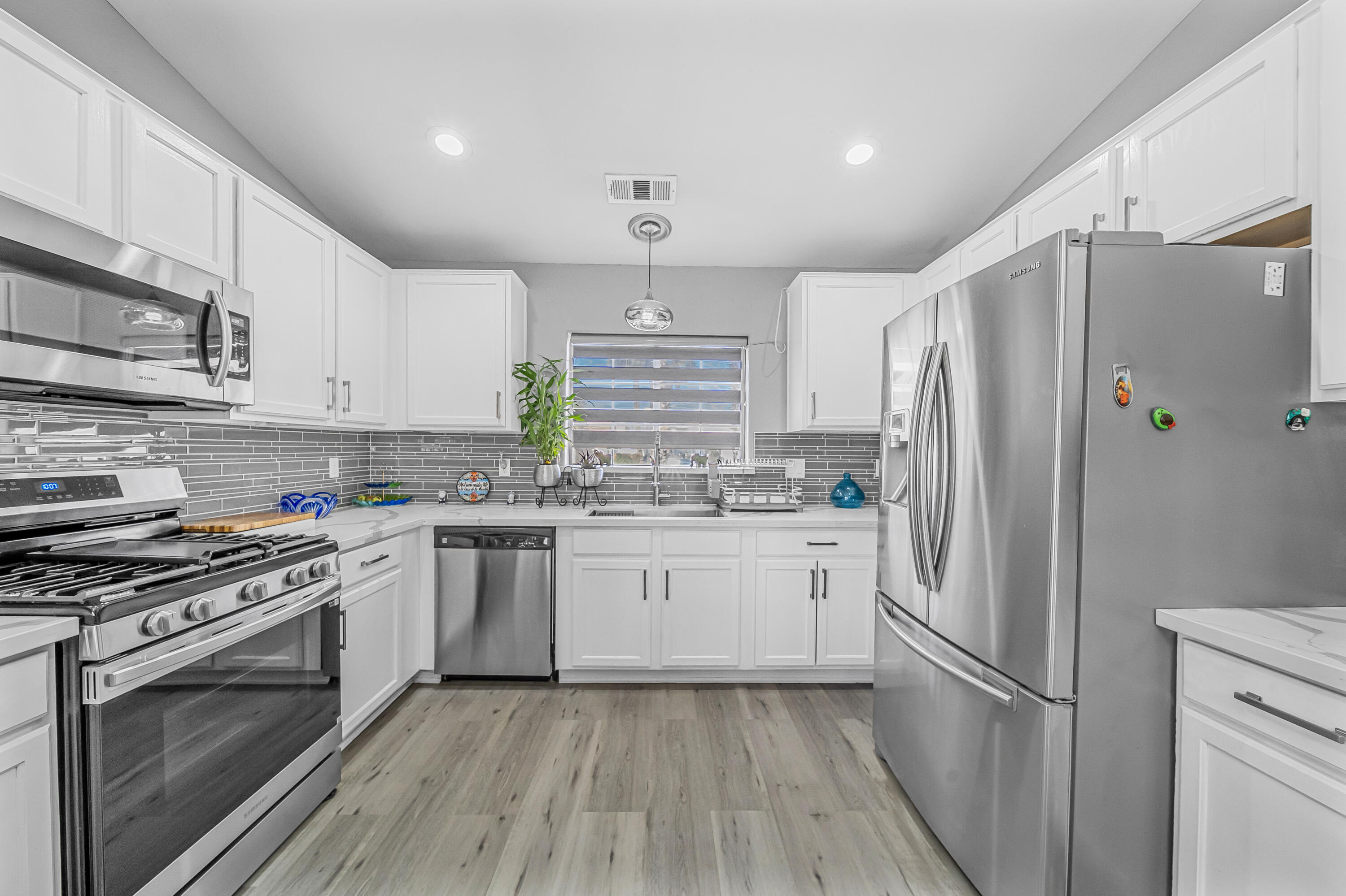 33860 Bell Road Thousand Palms, CA 92276 - Photo 11 of 56 a kitchen with stainless steel appliances a refrigerator sink and microwave