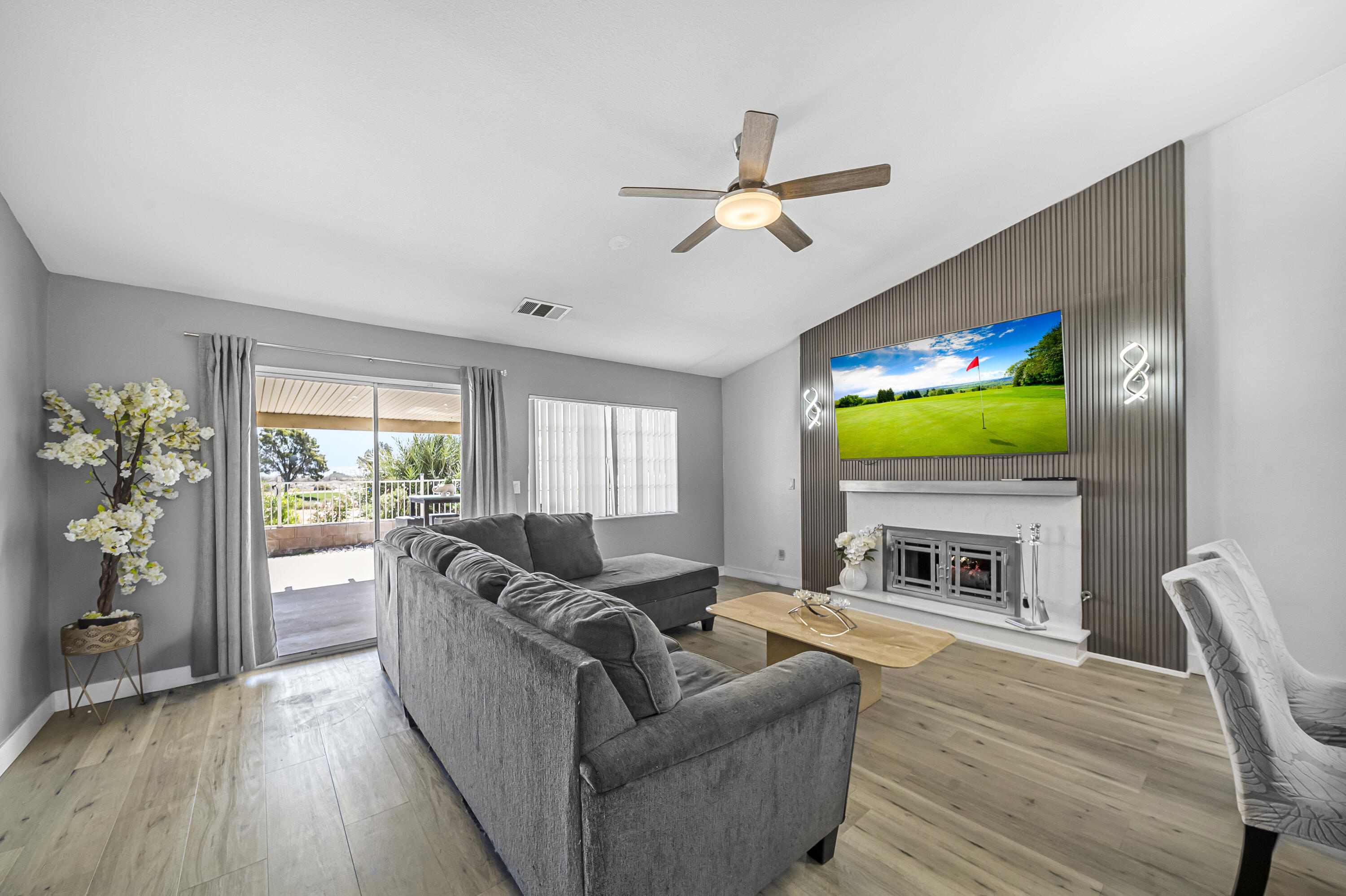 33860 Bell Road Thousand Palms, CA 92276 - Photo 14 of 56 a living room with furniture flat screen tv and a fireplace