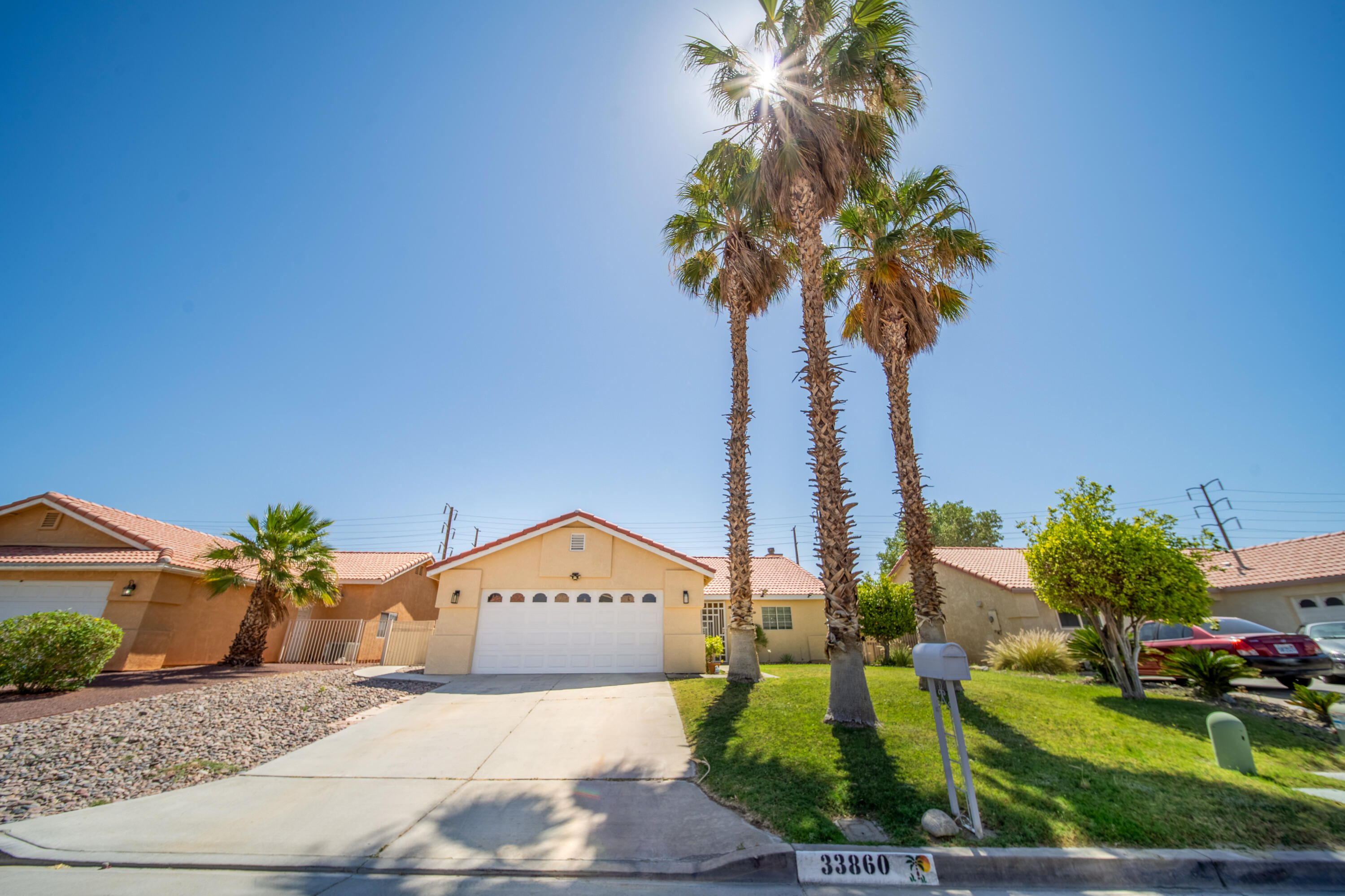 33860 Bell Road Thousand Palms, CA 92276 - Photo 2 of 56 a front view of a house with a yard and garage