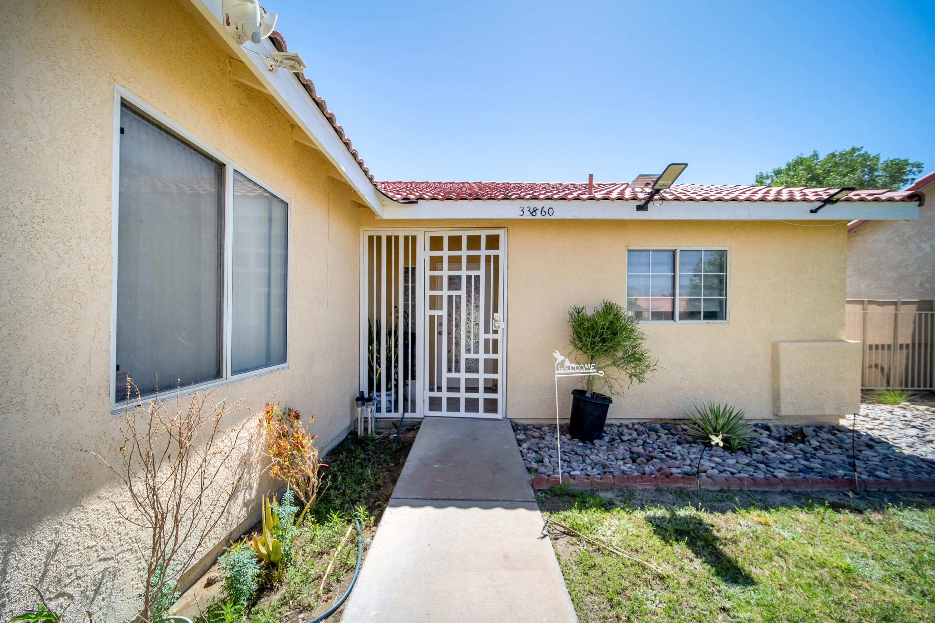 33860 Bell Road Thousand Palms, CA 92276 - Photo 3 of 56 a front view of a house with garden