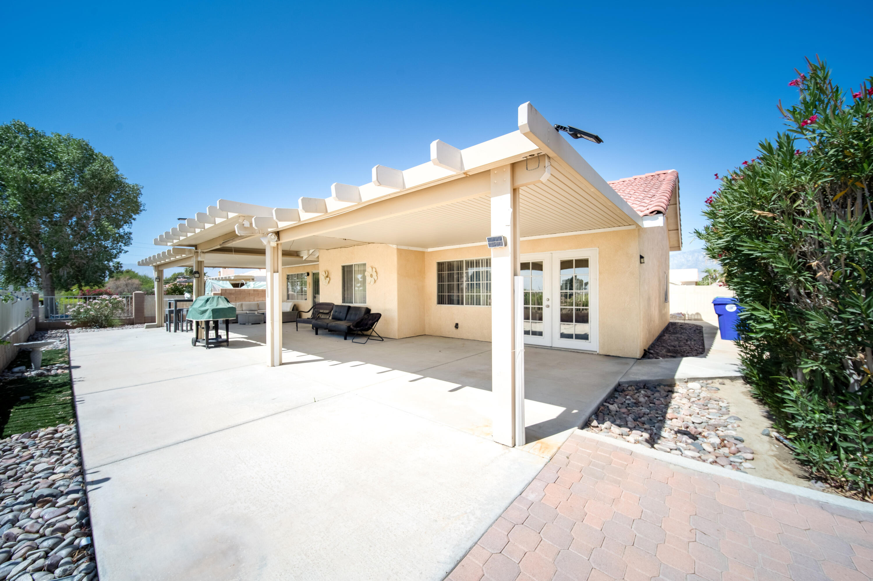 33860 Bell Road Thousand Palms, CA 92276 - Photo 33 of 56 a view of a white house with a patio