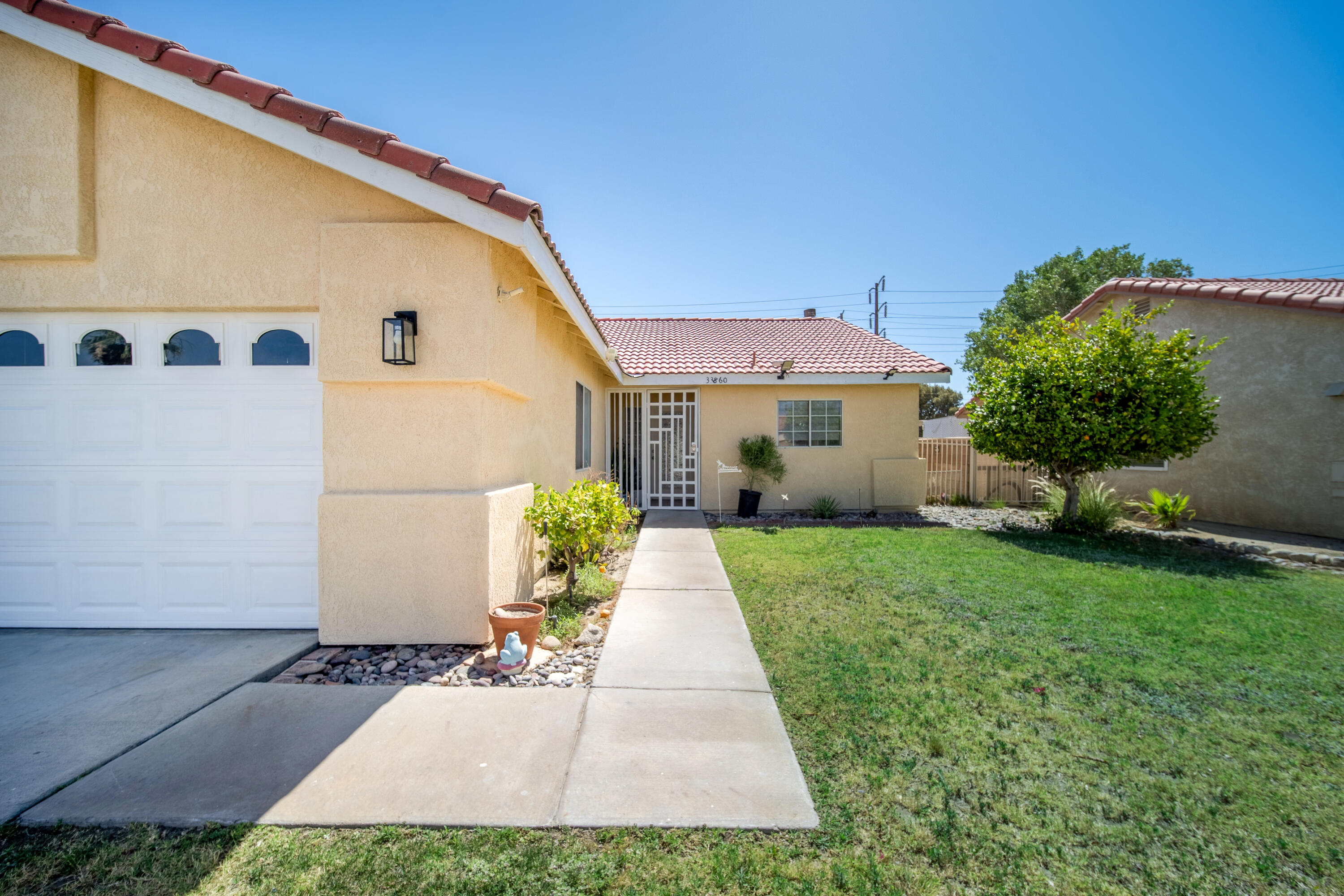 33860 Bell Road Thousand Palms, CA 92276 - Photo 42 of 56 a front view of a house with garden