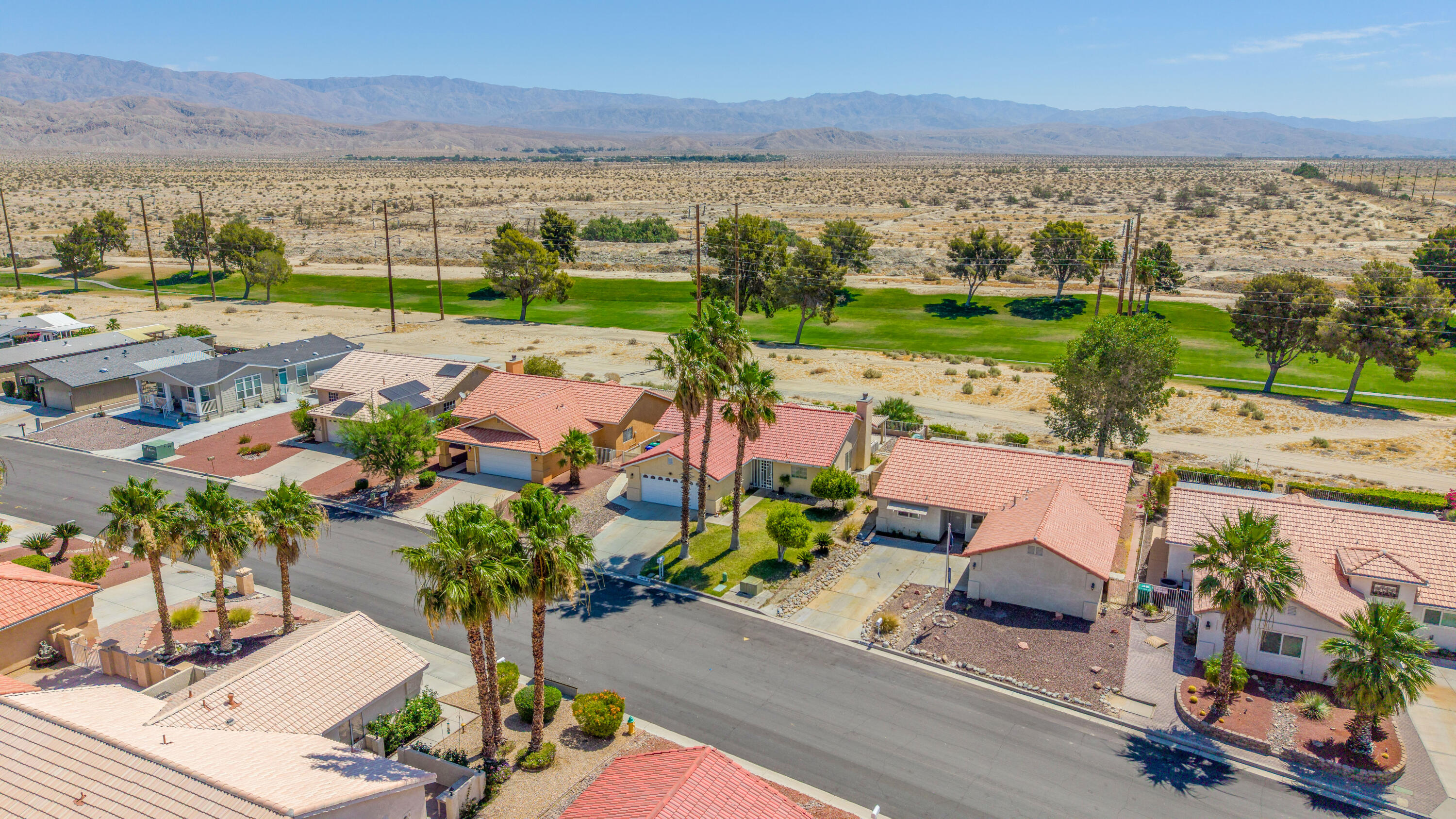 33860 Bell Road Thousand Palms, CA 92276 - Photo 47 of 56 an aerial view of residential houses with outdoor space and ocean view