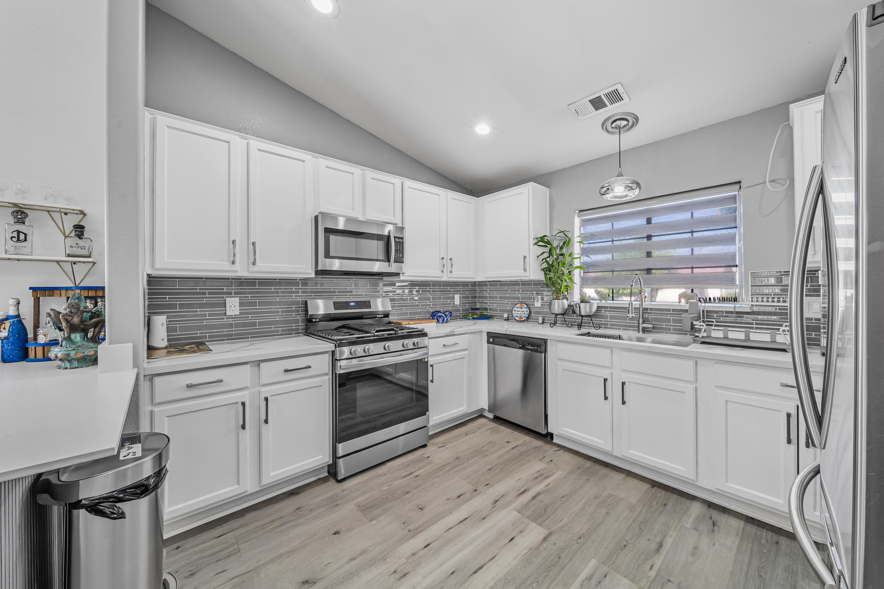 33860 Bell Road Thousand Palms, CA 92276 - Photo 10 of 56 a kitchen with granite countertop white cabinets and white appliances