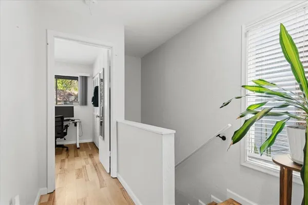 a bed sitting in a bedroom next to a window