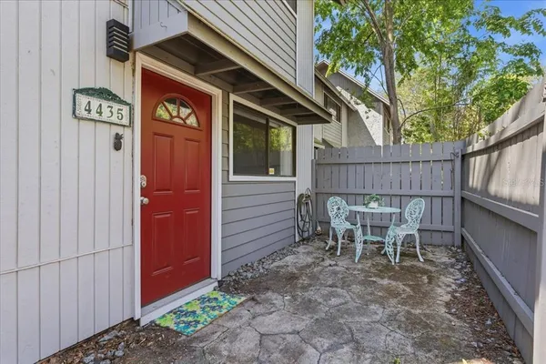 a backyard of a house with table and chairs