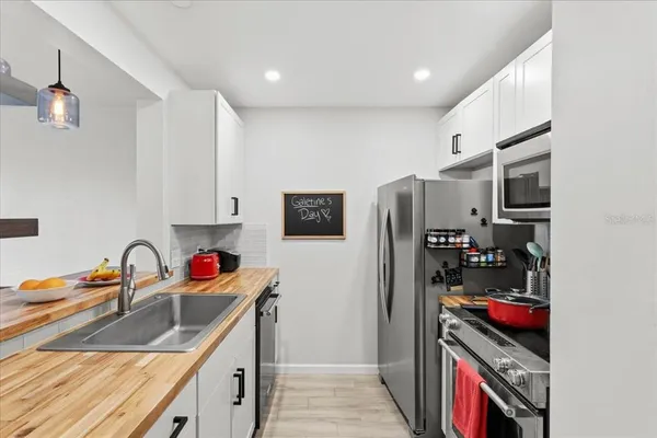 a kitchen with stainless steel appliances granite countertop a sink and cabinets