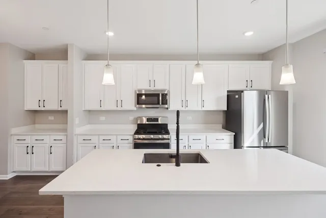 a kitchen with stainless steel appliances a refrigerator sink and microwave