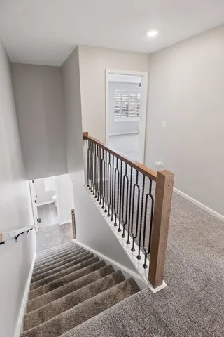 a view of a bedroom with wooden floor and a bathroom
