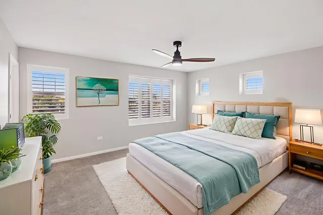 a bedroom with a large bed and a large window