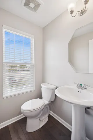a white toilet sitting next to a bathroom sink